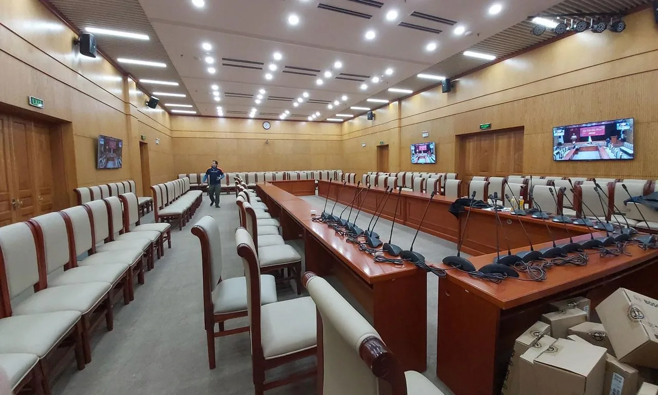 Large conference hall with delegate microphones and seating
