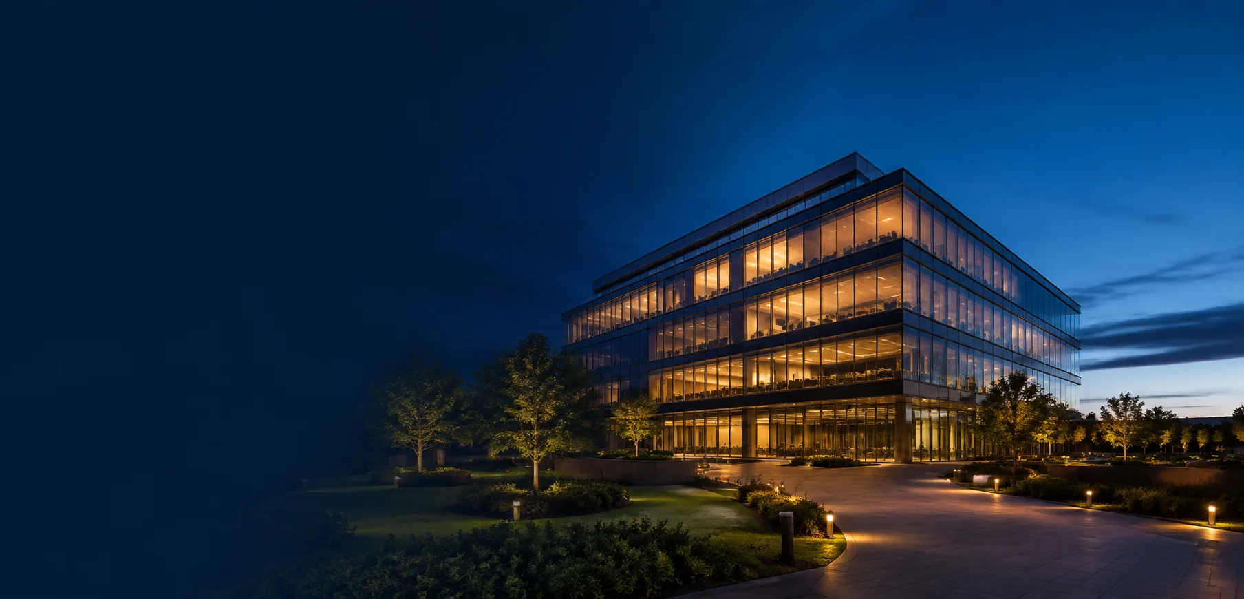 Modern glass technology office building illuminated at dusk
