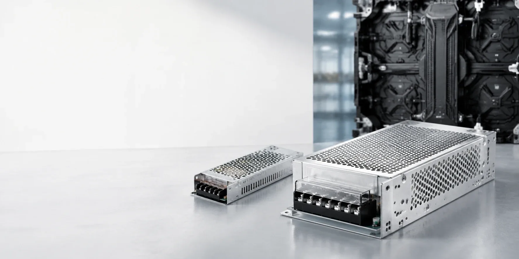Illustration of enclosed LED cabinet power supplies in a technical workspace